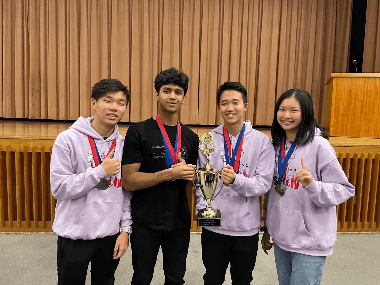 Four members with medals holding a first-place trophy
