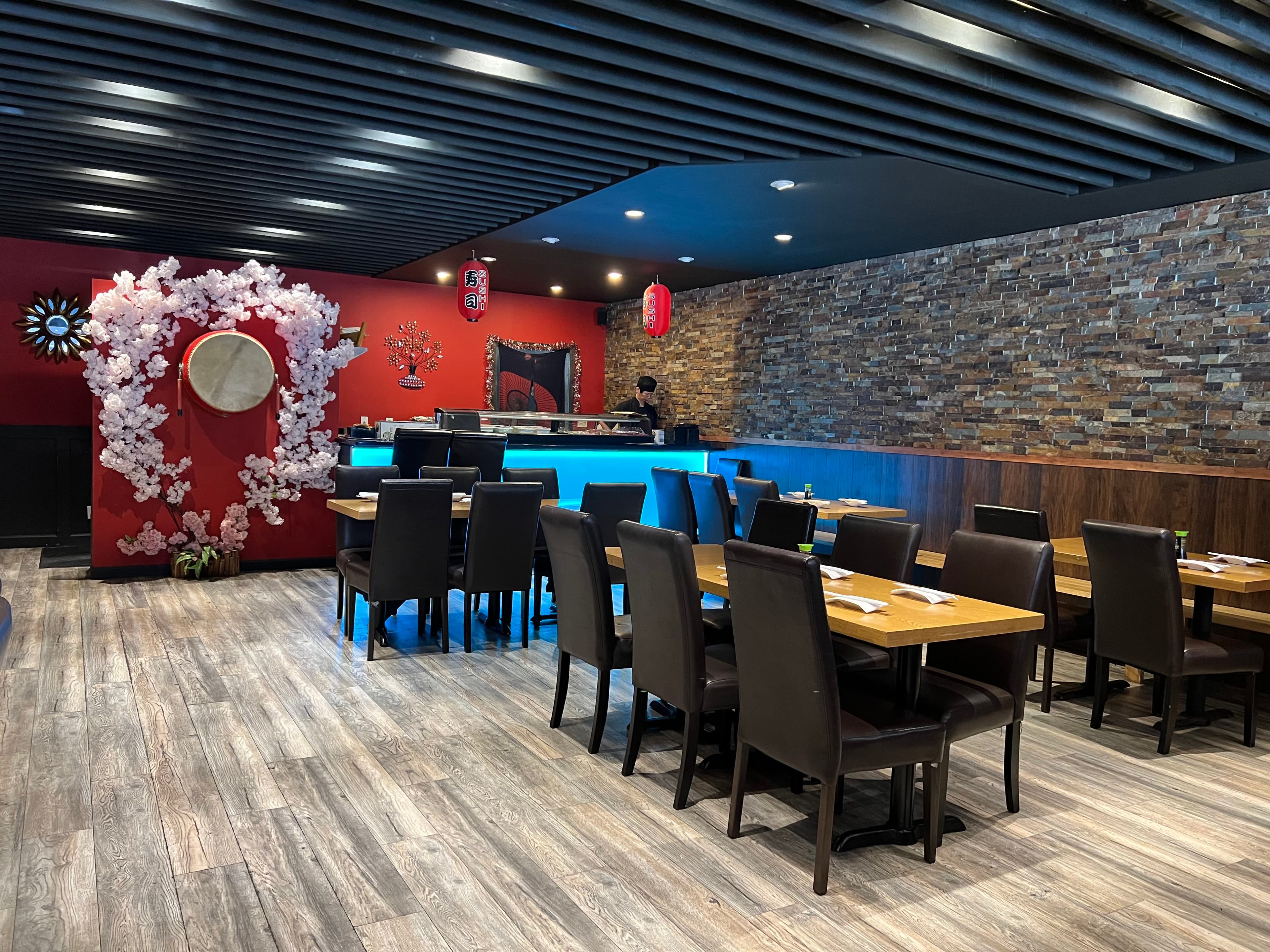 Yahao's dining room with a blossom arch and blue-lit sushi bar
